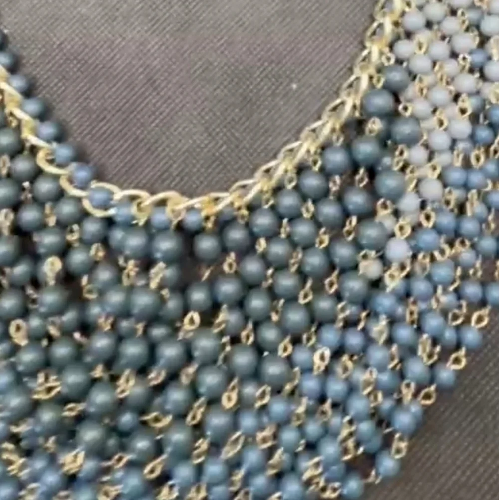 Gold plated cuban link chain with dangling graduated color jasper roundbeads